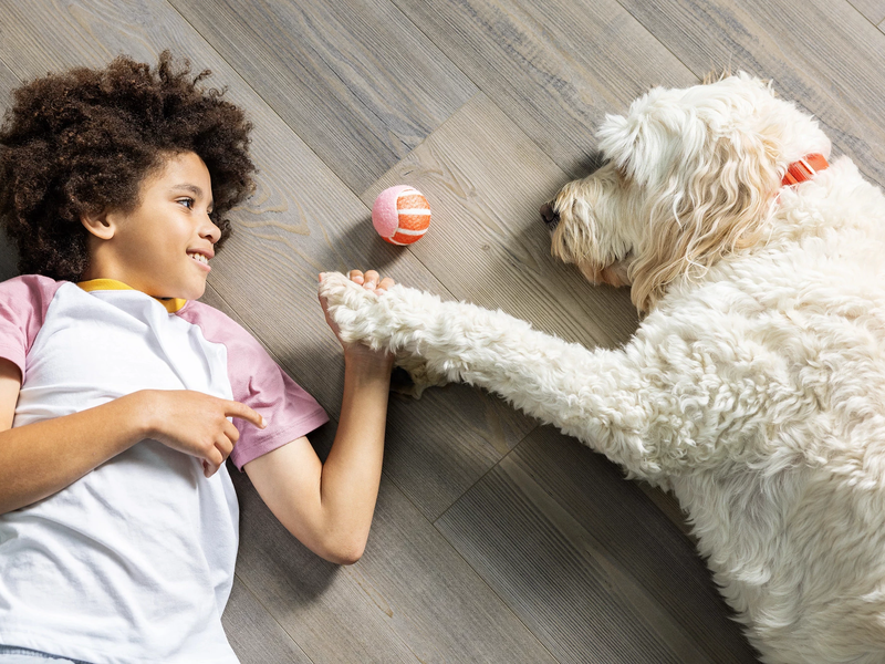 Child and dog laying on a COREtec floor